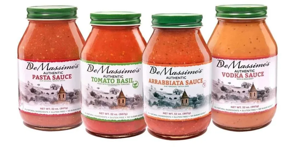 Four jars of De Massimo's pasta sauces arranged in one horizontal product lineup
