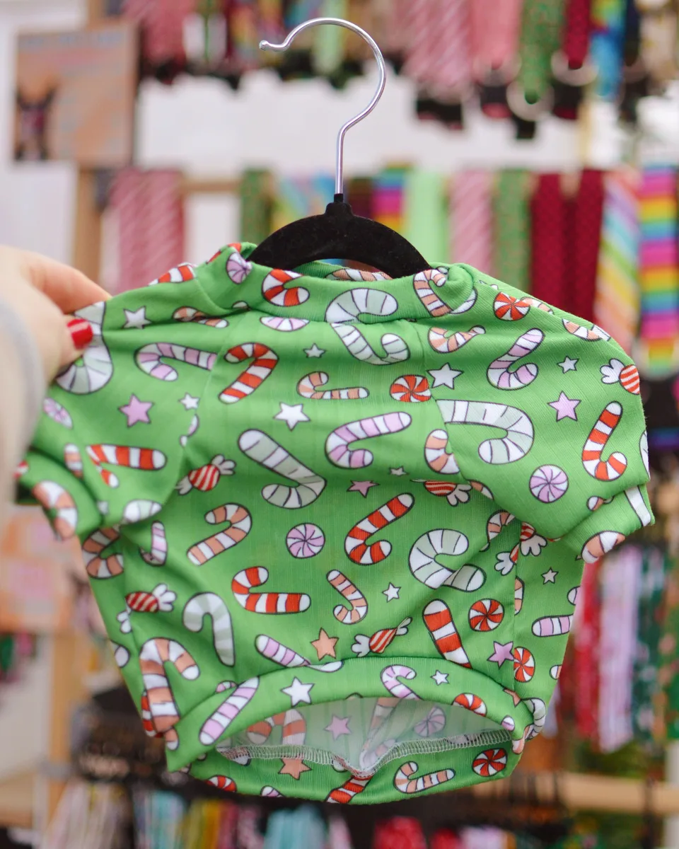 A green handmade pet shirt printed with colorful candy canes