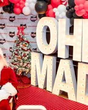 Santa sits in front of the marquee Ohio Made letters.