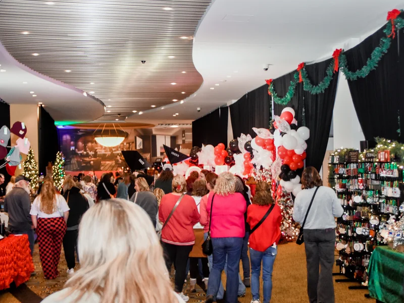 Shoppers walk the festive aisle between booths at the 2025 Ohio Made Holiday Market.