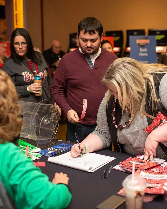 Guests fill out tickets beside a raffle drum at the 2018 Ohio Made Holiday Market.