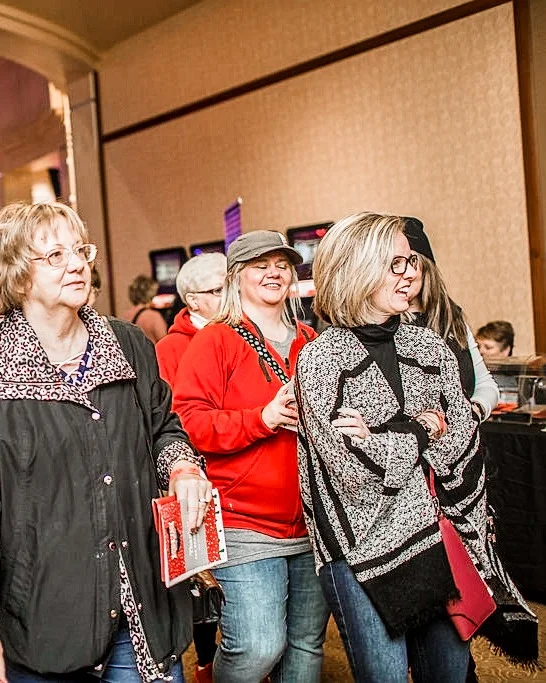 Three smiling shoppers pass through the 2017 Ohio Made Holiday Market.