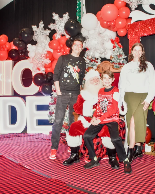 Guests share a holiday photo with Santa.