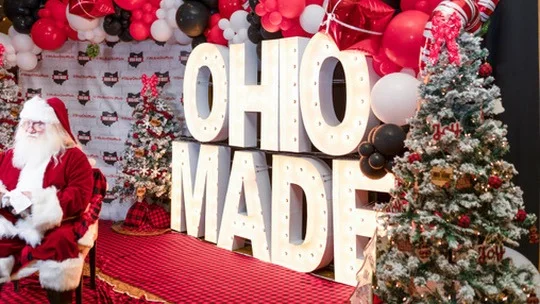 Santa sits beside the marquee Ohio Made letters.